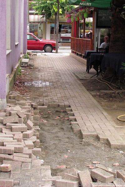 putting the bricks backin the sidewalk