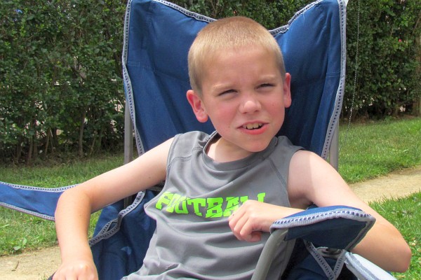 Caleb in a large lawn cchair
