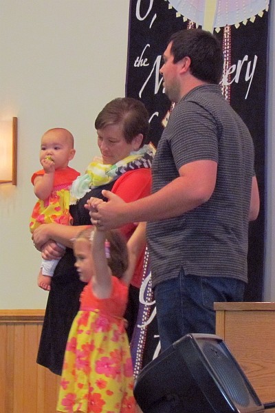 the Byler family during the dedication of Kiara at church