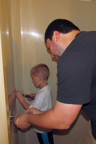Holden and Ty installing a grab bar in our shower