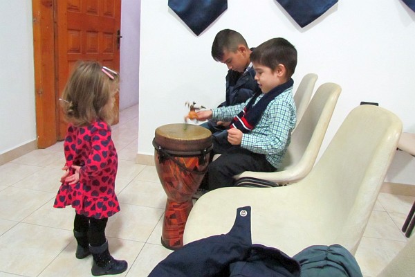 Paulo shows Sofia how the drum might be played