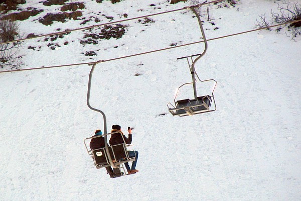 two riders on the chair liift