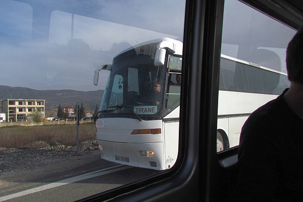 a large bus passes us going toward Tirana