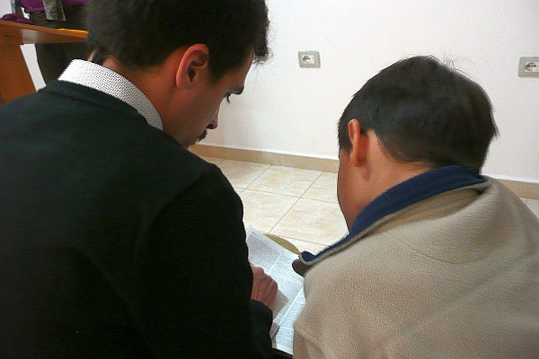 Francis and Samuel reading the Bible together in church