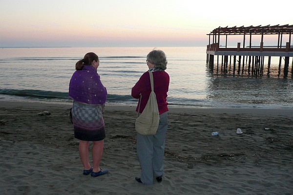 Bardha and Elsie conversing on the beach