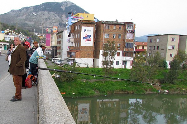 fishing the Drini River from a city bridge