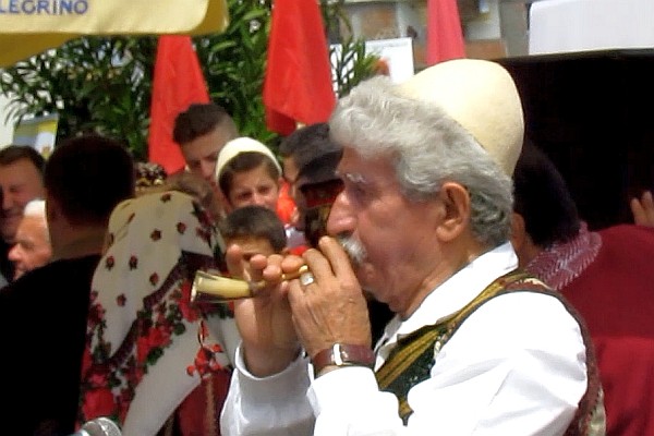 a man playing a small horn