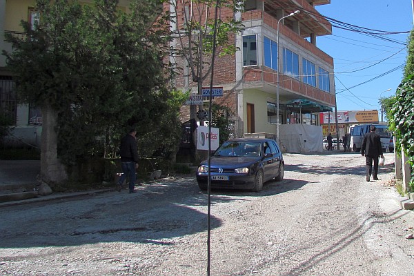 a dirt street in Tirana