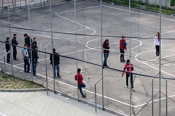 boys and girls in separate groups on the playground