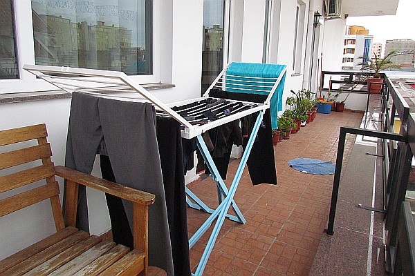 balcony on the side of our apartment with drying rack