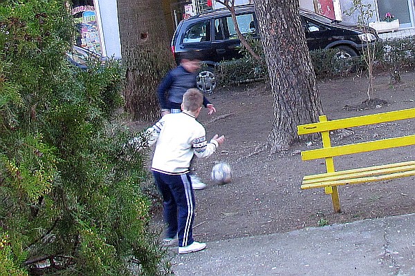 two boys playing pick-up "futboll"