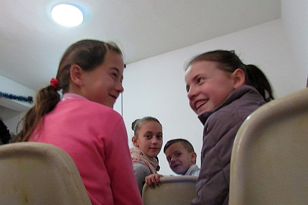 children at church talk to each other