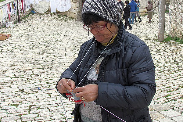 a woman knitting inside the castle