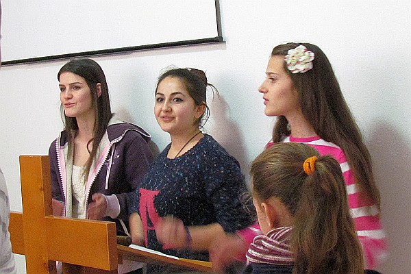 three girls sing in the worship time
