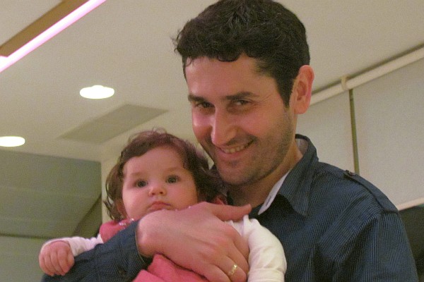 Tonin holds his and Alba's daughter, Mia 