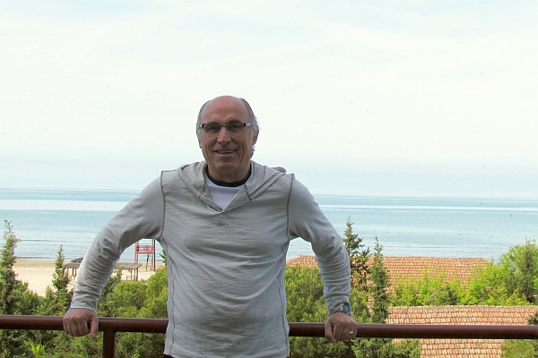 Dini on the balcony with the Adriatic Sea at his back