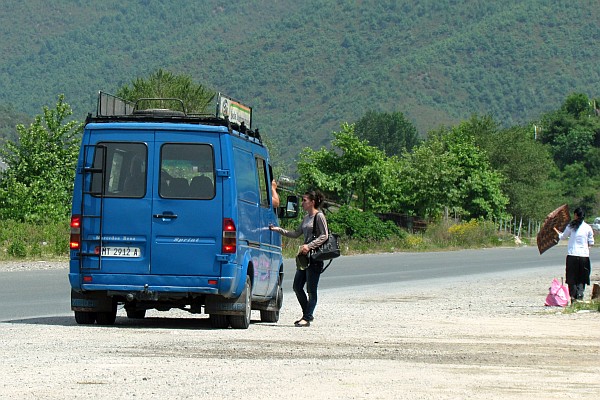 a passenger catches a furgon in Milot