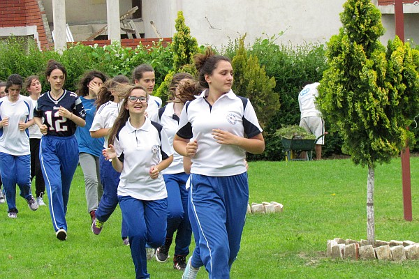 girls' PE class warms up running