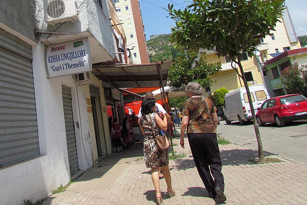 Klementina & Elsie walking past the Guri i Themelit church