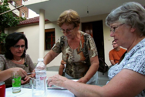 Klementina's sister serves her and Elsie as we all await to sample the delecicacies 