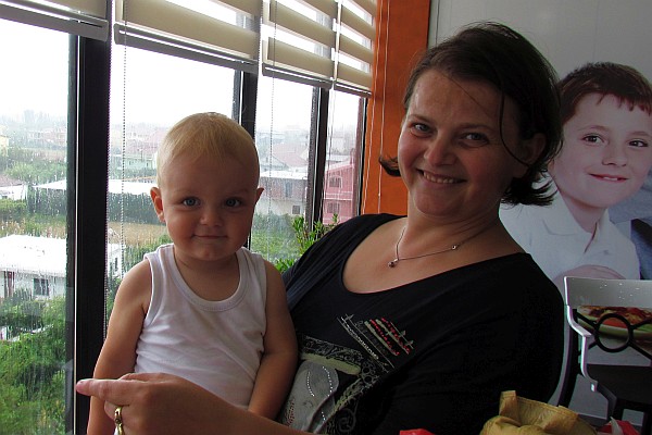 a small boy and his mother at lunch