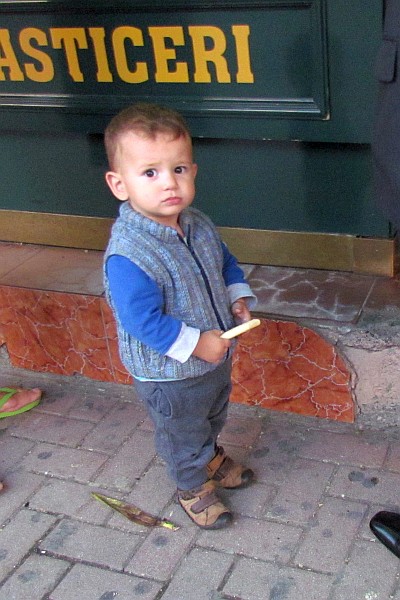 a young boy checks me out at the byrek shop