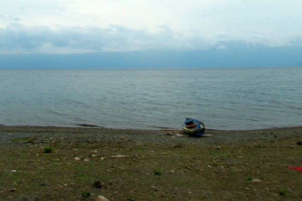 a fishing boat along the lake shoore
