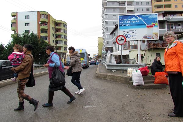 crossing the busy bridge by the market