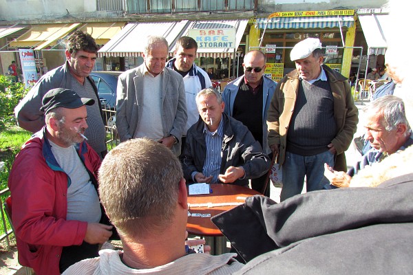 men in Beral playing a serious game of dominoes
