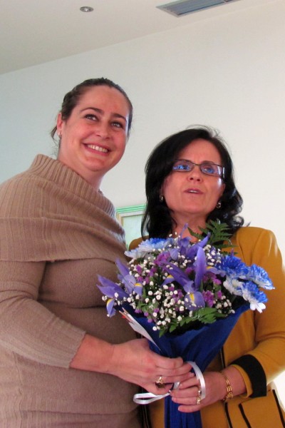 Klementina gives some flowerrs to Bardha as birthday wishes from us