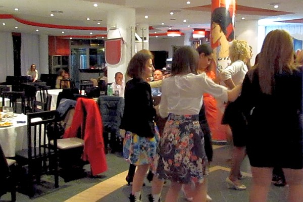 the women dance past some empty talkes