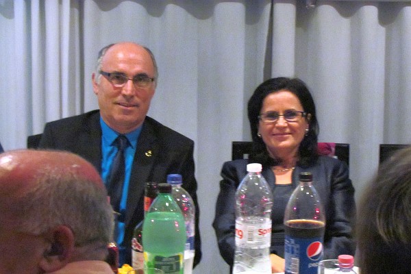 Dini and Klementina sit at the head table and take it all in