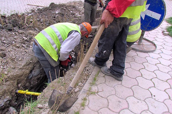 men digging the ditch for the electrical cable