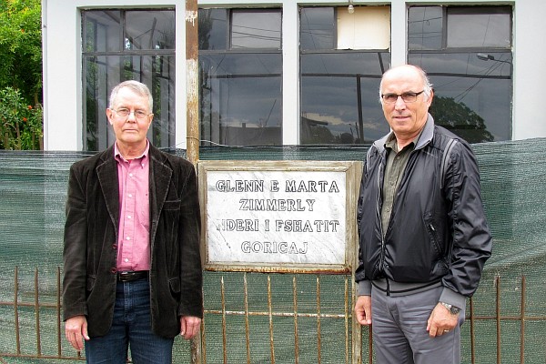 Allen and Dini stand in front of the plaque for the Zimmerly's