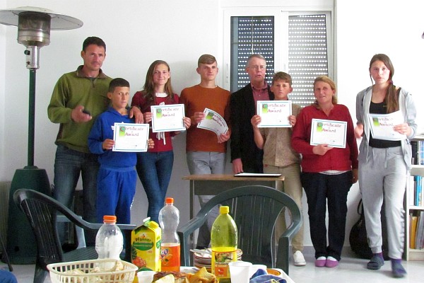 the Koloshi children and mother get certificates for English class