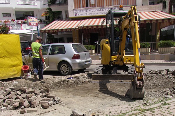 worker copvering up the newly laid electrical cable
