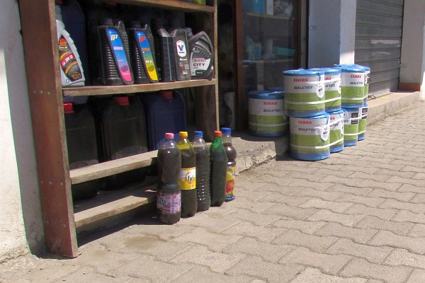 outside a shop selling oil, baler twine, etc.