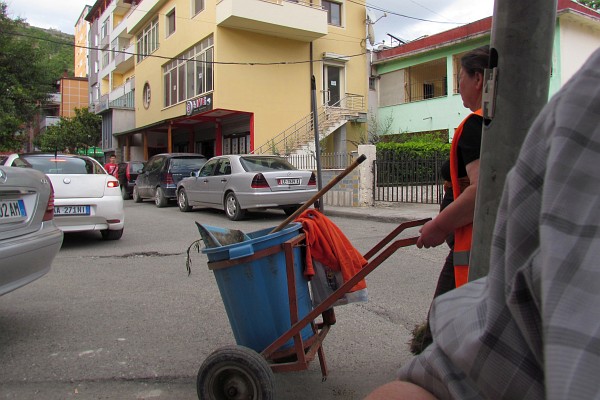 a worker cleans the street