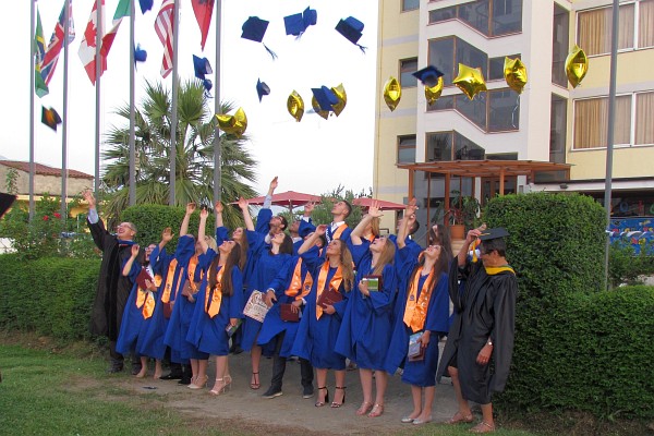 seniors line up to throw their mortarboards in the air