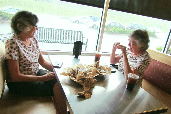 Elsie (L) and her sister Alice share conversation at a restaurant