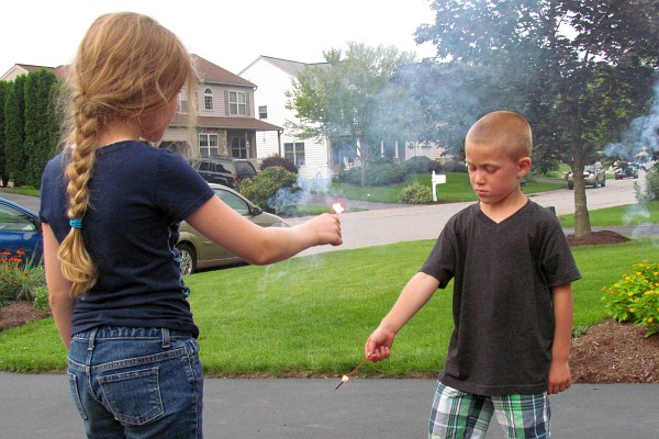 Maya and Ty hold their sparklers