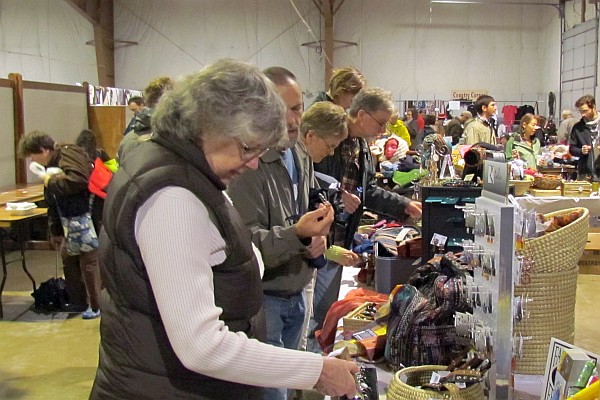 Elsie looking over the wares at the Artisan's Hope booth