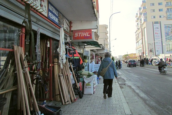 Elsie walking past the shops across from the "market"