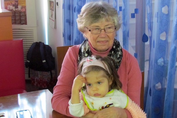 Elsie holds Sofia, the pastor's daughter