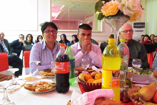 Fatlum and his mother sitting beside John Janett