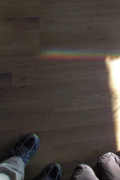 a colorful spectrum of light from a dsoor in  a coffee bar