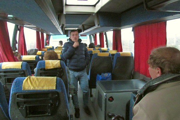the person who helps persons on and off fthe bus and colelcts the fares