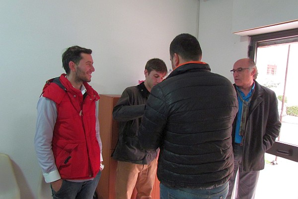a group of men make an informal welcoming committee