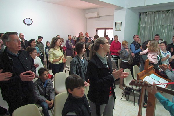 standing to sing in a packed church 