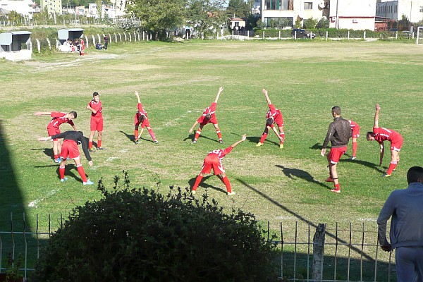 a football team warms up for a Sunday morning game